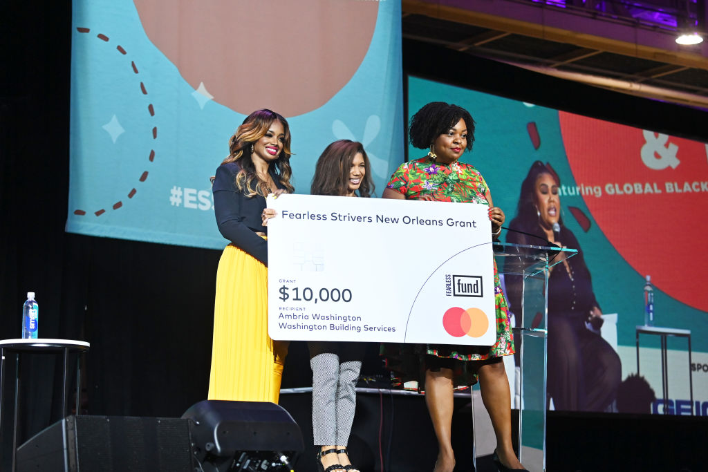 NEW ORLEANS, LOUISIANA - JULY 01: Arian Simone (L) presents the Fearless Strivers New Orleansn Grant onstage during the 2022 Essence Festival of Culture at the Ernest N. Morial Convention Center on July 1, 2022 in New Orleans, Louisiana. (Photo by Paras Griffin/Getty Images for Essence)