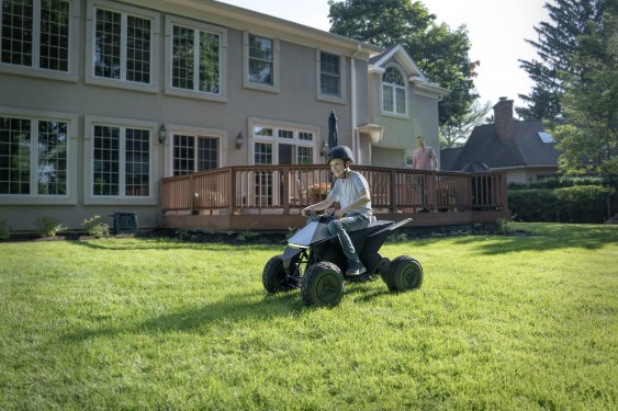 Child driving Cyberquad for Kids across lawn