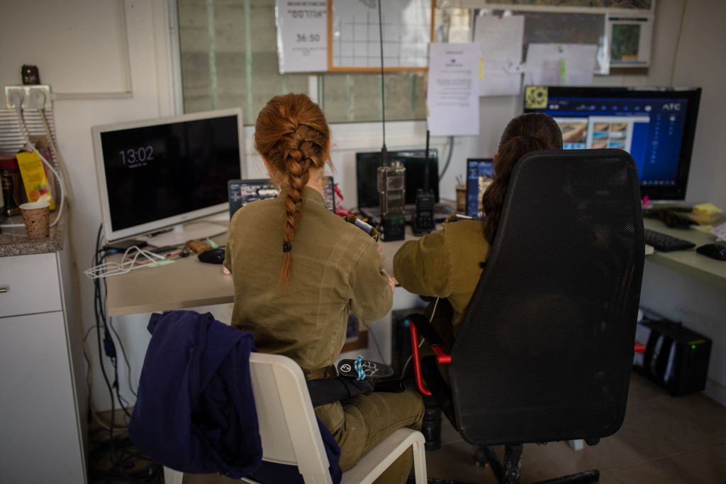 Bethlehem, Palestine. Two 19-year-old Israeli Defence Force soldiers monitor CCTV video feeds at an outpost overlooking Husan in the settlement of Sde Boaz in the West Bank. Their faces and computer screens have been hidden for security reasons.