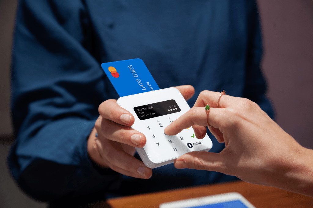 person using payments device/card reader