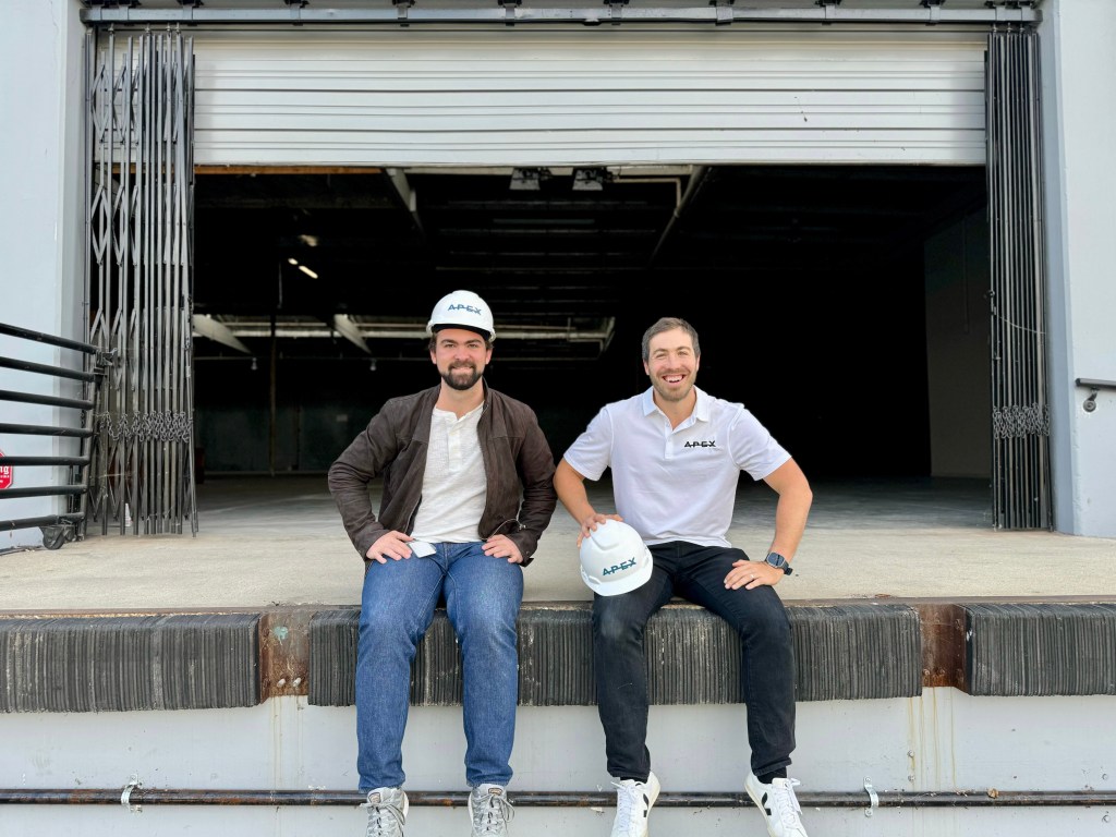 Apex Space founders sitting on loading dock