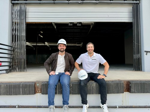 Apex Space founders sitting on loading dock