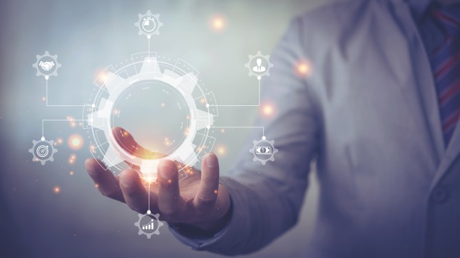 Workflow automation concept with person holding a gear surrounded by various tasks.