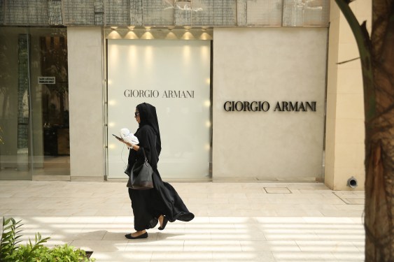A woman walks past a Giorgio Armani shop at an upscale shopping center in Jeddah, Saudi Arabia.