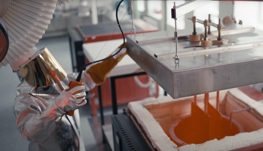 A scientists lifts the lid of Up Catalyst's prototype reactor.