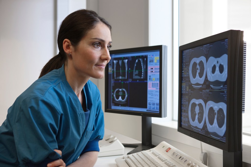 Doctor looking at x-rays from CT-scanner on computer