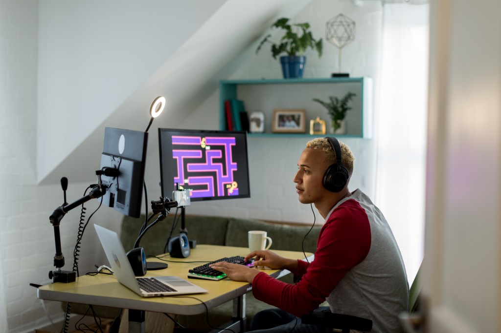 Young gamer playing online in his bedroom