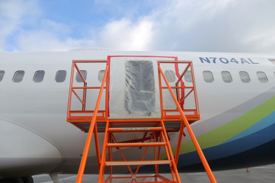plastic covers the exterior of the fuselage plug area of Alaska Airlines Flight 1282 Boeing 737-9 MAX on January 7, 2024 in Portland, Oregon. A door-sized section near the rear of the Boeing 737-9 MAX plane blew off 10 minutes after Alaska Airlines Flight 1282 took off