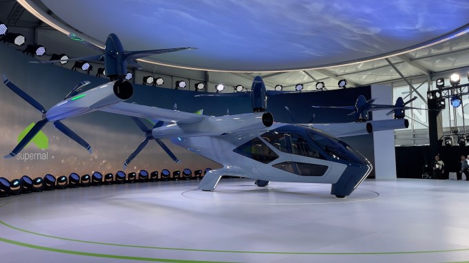 an electric air taxi paint in white sits on a platform at CES 2024