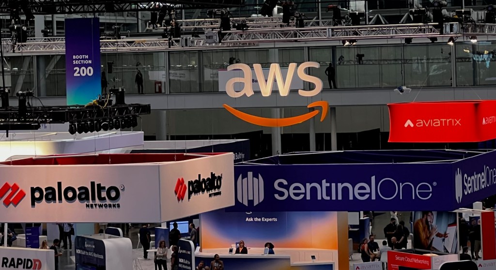 Conference floor with booths from companies like AWS, Palo Alto Networks, Rapid 7 and others taken from above.