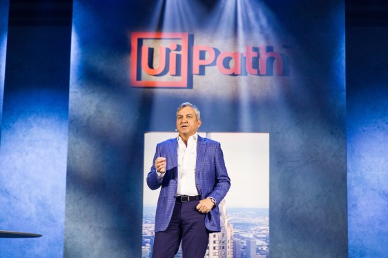 UiPath CEO Rob Enslin in front of UiPath logo.