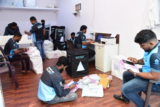 men sitting in sorting center office