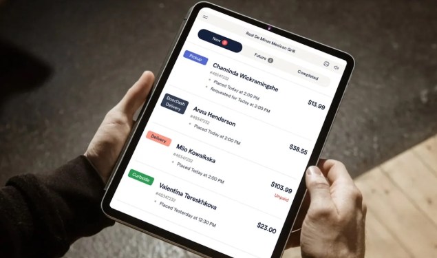 person holding tablet displaying ChowNow app
