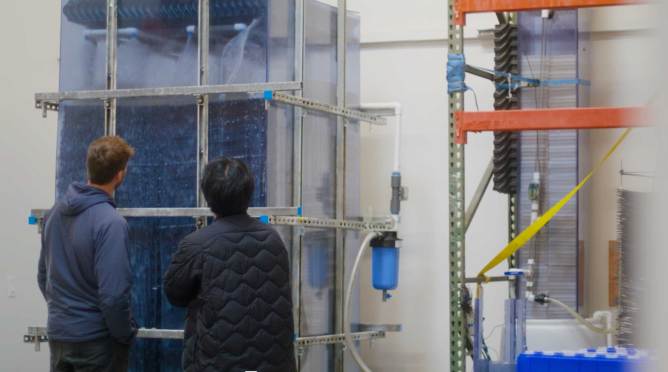 AirMyne employees inspect a direct air capture prototype.
