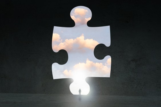 Puzzle piece pulled out to reveal cloud behind it.