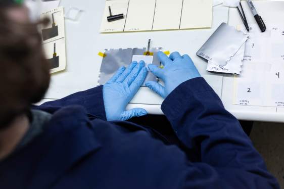 A man making a battery in a lab.
