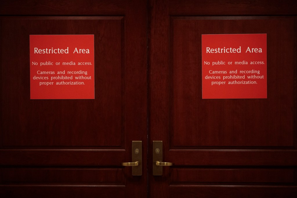 Doors to the Sensitive Compartmented Information Facility (SCIF) are seen where closed-door hearings