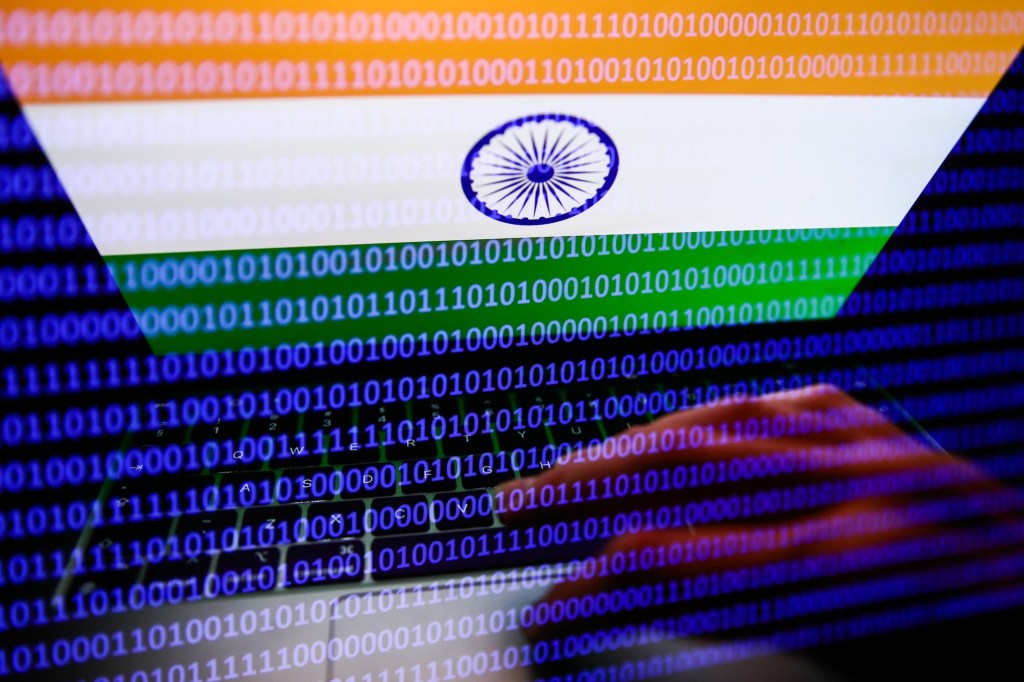 Flag of India displayed on a laptop screen and binary code displayed on a screen are seen in this multiple exposure illustration photo