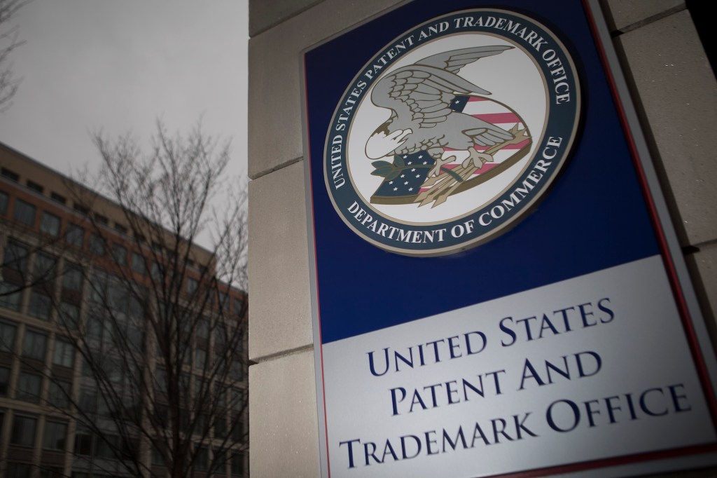 The U.S. Patent and Trademark Office (USPTO) seal is displayed outside the headquarters in Alexandria, Virginia,