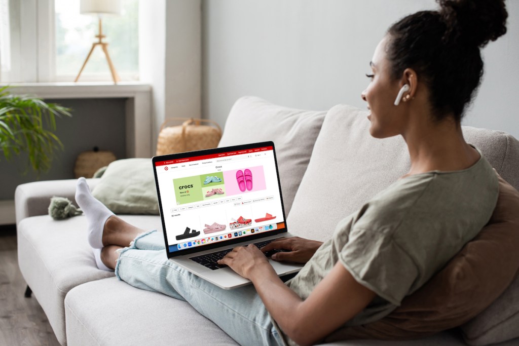 woman on couch working on laptop