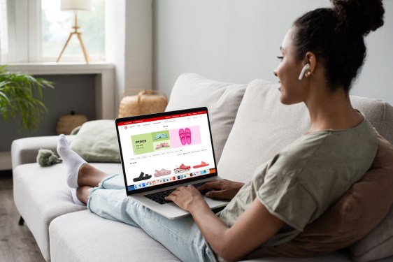 woman on couch working on laptop
