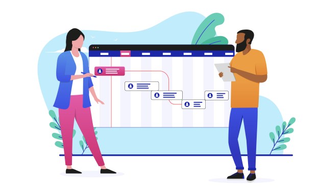 Two business people standing front of a project plan.