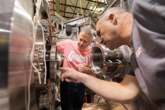 Jay Anderson and Kieran Furlong inspect the WHAM experiment at University of Wisconsin-Madison.