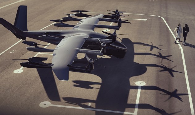 Archer Aviation midnight evtol on tarmac with two women walking up to board.