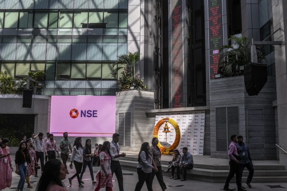 people walking past NSE sign