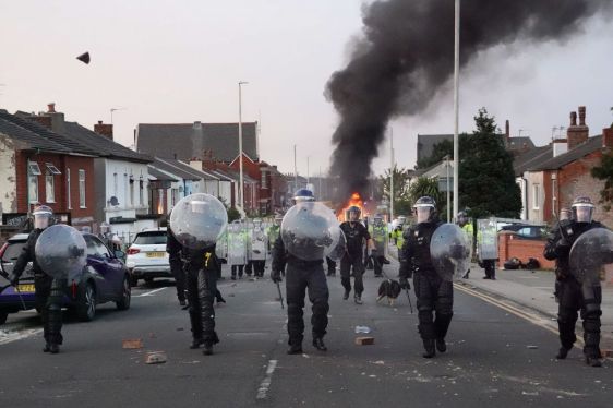 Riot police hold back protesters after disorder broke out on July 30, 2024 in Southport, England.
