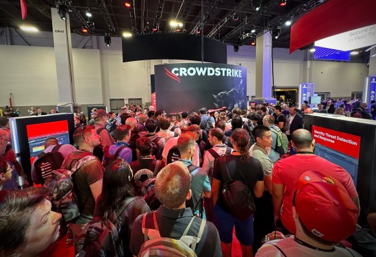 a busy scene of people at the line to get action figures at the CrowdStrike booth, located in the business hall of the Black Hat cybersecurity conference in Las Vegas, on August 7, 2024