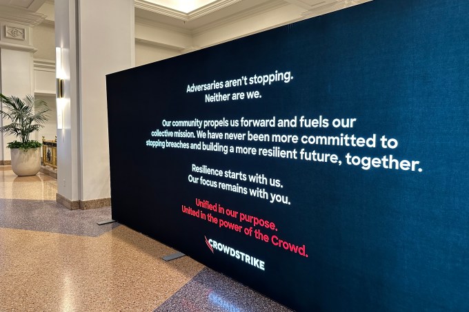 A message from CrowdStrike to the attendees of the Black Hat cybersecurity conference on a television screen, saying: "Adversaries aren’t stopping. Neither are we."