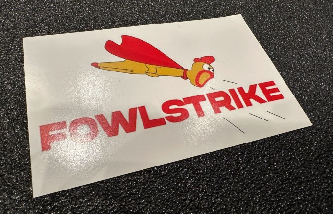 a sticker featuring a chicken with a cape, and the word "FOWLSTRIKE."
