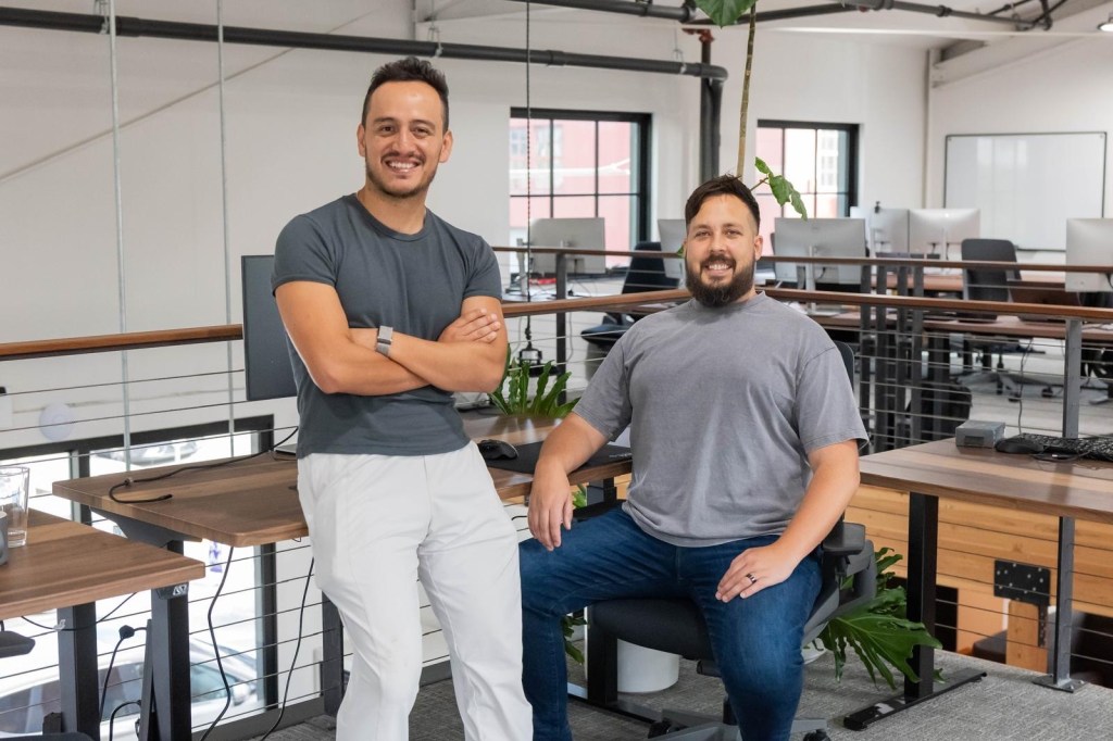 2 men sitting in office