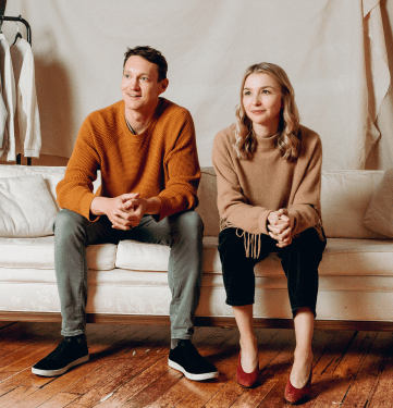 Archive founders Ryan Rowe and Emily Gittins sitting on a couch