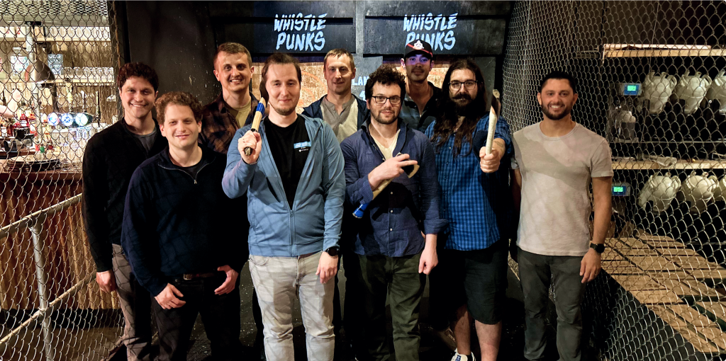 Image of the Plural team at an axe-throwing establishment.